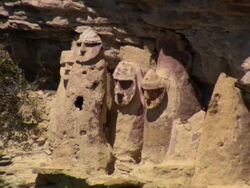 "L-R pan of ancient cliffside Chachapoya sarcophogi, bright sunshine, one has become the nest for a swarm of killer bees, Amazonas region of Peru [PerÃƒÂº]" Stock Footage