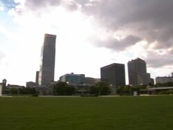 Wide Shot pan-right-Billowy clouds hover over the Milwaukee skyline with the Milwaukee Art Museum in view. / Milwaukee, WI Stock Footage