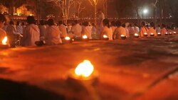 Buddhism lighted candles trail around ancient temple Stock Footage