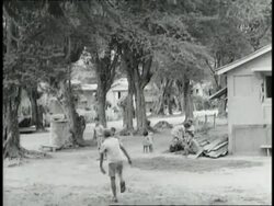 Young children play stickball near a home in Saipan. News Clip