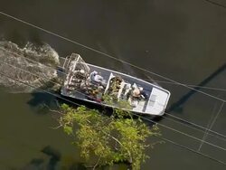 Sept. 11, 2005 aerial soldiers in airboat on flooded street in wake of hurricane / New Orleans Stock Footage