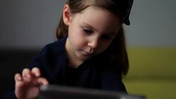 Little cute girl using tablet PC Stock Footage