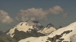 Clouds drift over snow-covered glacial peaks. Stock Footage