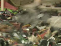 MS R/F Shot of boy shovels old electronics components into basket / Shenzen, China Stock Footage