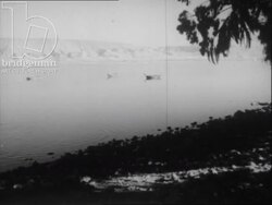 Camels drinking from trough, fishermen pulling nets out of the Sea of Galilee, Israel 1940s Stock Footage