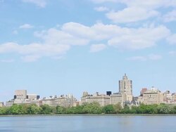WS PAN View of Clouds over fresh green trees and Central Park East Residences at Reservoir / New York, United States  Stock Footage