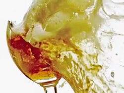 CU SLO MO Glass of beer exploding and splashing / vieux pont en auge, Normandy Stock Footage