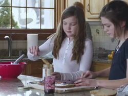 MS TU TD Kids making sandwich while dad takes it with mother in background / Rutland,Vermont, USA Stock Footage