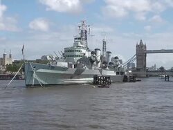 WS View of HMS Belfast in front of Tower Bridge / London, United Kingdom Stock Footage