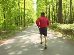 HD STEADY: Jogging Through Green Forest Stock Footage