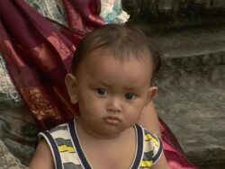 ZO Young child and mother relaxing at Angkor Wat / Cambodia Stock Footage