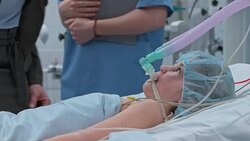 Child on breathing machine in ICU visited by parents Stock Footage