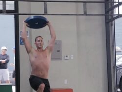 Medium frame. Steven performs series of overhead lunges. Stock Footage