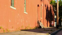 MS Female athlete running on urban street at sunrise Stock Footage