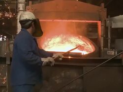 MS ZI  Worker working at inductive heating furnace of foundry / Juenkerath, Rhineland-Palatinate, Germany  Stock Footage