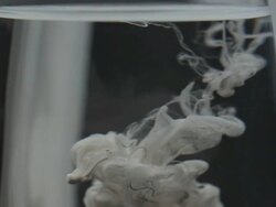 ECU SLO MO Shot of white ink dissolving in glass of water / Seoul, South Korea Stock Footage