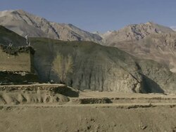 MS Villagers threshing barley in spectacular mountains / Saldang village, High Himalayas, Upper Dolpo near Tibetan border, Nepal   Stock Footage