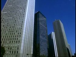 MS low angle, side angled view of tall skyscrapers against blue sky, Shinjuku, Tokyo, Japan Stock Footage