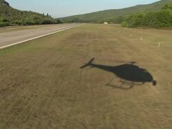Following Helicopter Shadow Landing At La Mole Airport Stock Footage