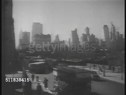 1937: NEW YORK CITY: XWS (POV Boat) Lower Manhattan w/ Upper New York Bay FG. HA WS Street bordering park, double-decker bus FG. STREET SCENE: People in coats, hats walking sidewalk, crossing street. Instructional Video