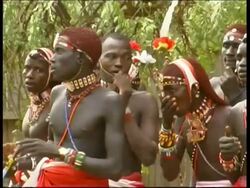 Samburu men singing, CU zoom out, Kenya Stock Footage
