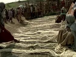 Ethiopian woman selling ropes at camel market Stock Footage