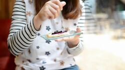 HD:Young woman eating blueberry cheese pie cake Stock Footage