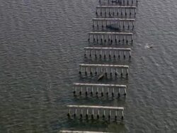 Aerial over Bay of Biloxi and destroyed Biloxi-Ocean Springs bridge / Mississippi Stock Footage