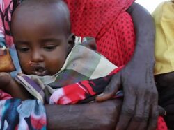Woman holding child eating bread Stock Footage