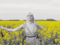 HD SLOW MOTION: Woman Hopping Through Canola Field Stock Footage
