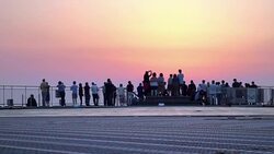 people on patio watching sunrise Stock Footage