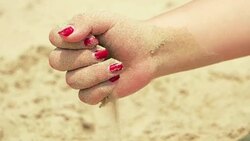 sand in the hands of woman Stock Footage