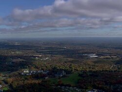 WS AERIAL Wooded area with autumn colors and small town nesting in trees / Connecticut, United States Stock Footage