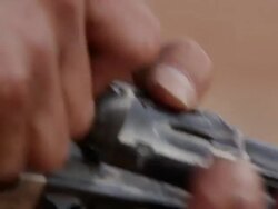 Up close view of bullets in mans hands as he loads his old pistol. Stock Footage