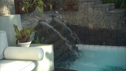 A water fountain sprays into a swimming pool at La Maison Hotel in Rio de Janeiro. Stock Footage