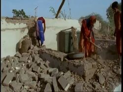 MS Gujarat, Indian family clearing house demolished by earthquake, Gujarat, India Stock Footage