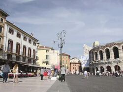 MS Cafes and Restaurants at Piazza Bra and Tourists roaming in front of Arena di Verona / Verona, Veneto, Italy Stock Footage