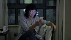 Old woman using mobile phone at home Stock Footage