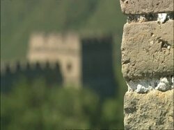 Pull focus from bricks in battlement to watch tower on Great Wall of China, Mutianyu, China Stock Footage
