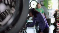 Bike salesman points out new bicycle to customer and offers professional opinion Stock Footage