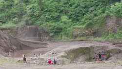 Volcanic debris and water flows through Indonesian village Instructional Video