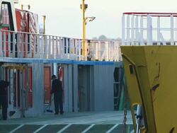 MS PAN Yellow ferry sailing away with people sweeping its floor / Chacao, Region de Los Lagos, Chile Stock Footage