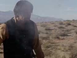 Cowboy shooting pistol and walking as he shoots. Stock Footage