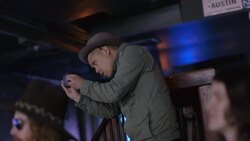 Man stands above crowd at rock concert to take photos with smartphone Stock Footage