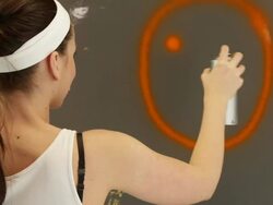 Young woman painting happy smile sign. Stock Footage