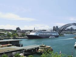 The Ocean Liner "Amsterdam" at the Ocean Terminal with Harbour Bridge and Ferry Terminal, Sydney, New South Wales, Australia Stock Footage