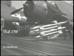 1940s: UNITED STATES NAVY: VS U.S. Navy crewmen wheeling various bombs & missiles on carrier deck to arm fighter & bomber planes. WWII, World War II, Pacific Front Instructional Video