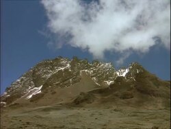 WA Rocky mountain with small amount of snow, against blue sky, wispy clouds, Ethiopia, Africa Stock Footage