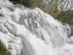 MS Shot of Sulphurous water plunges in waterfall in thermal pools / Saturnia, Tuscany, Italy Stock Footage