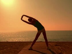 MS Lady exercising for fitness at beach / San Pedro Alcantara, Malaga, Spain Stock Footage